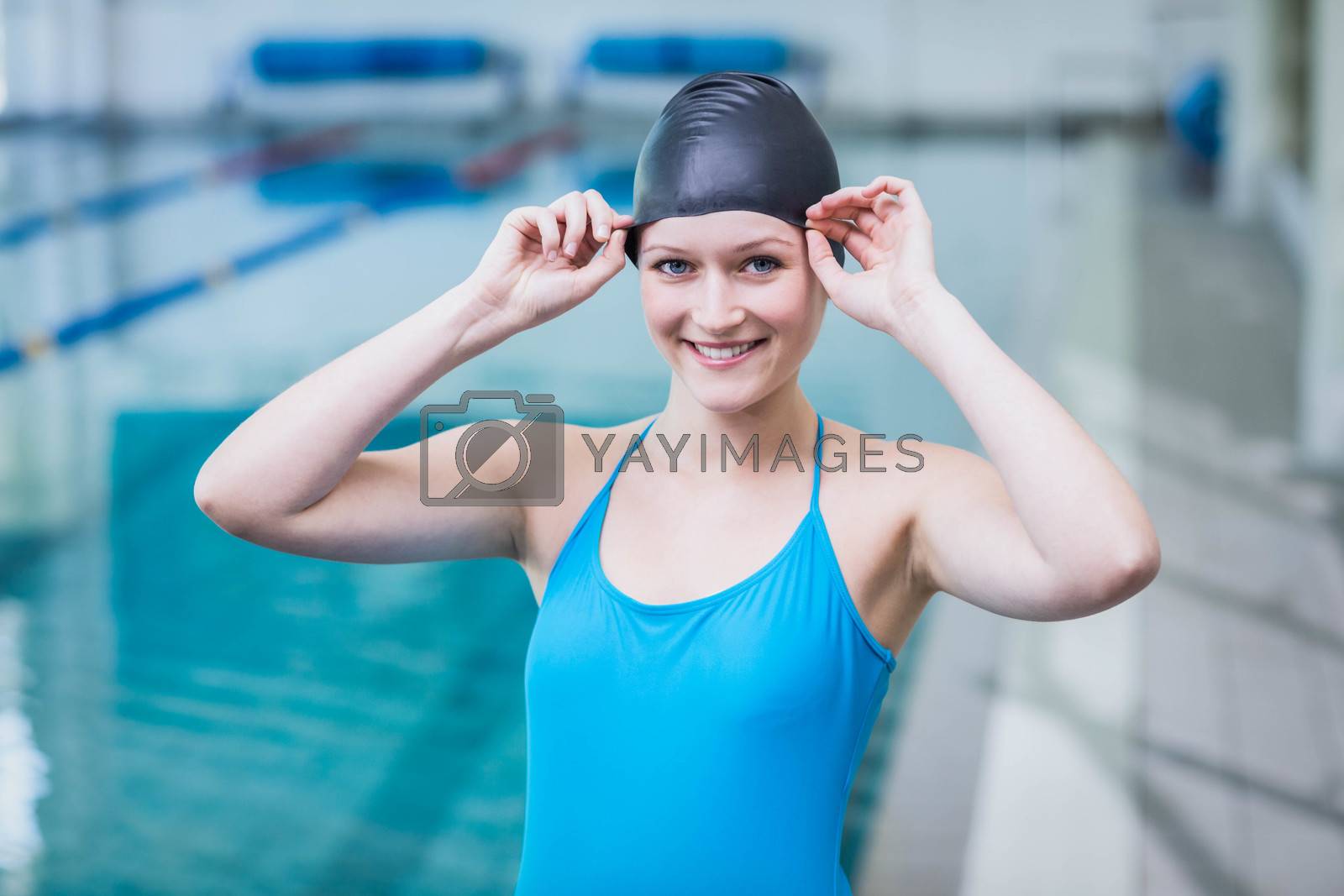 Royalty free image of Cute woman wearing swim cap by Wavebreakmedia