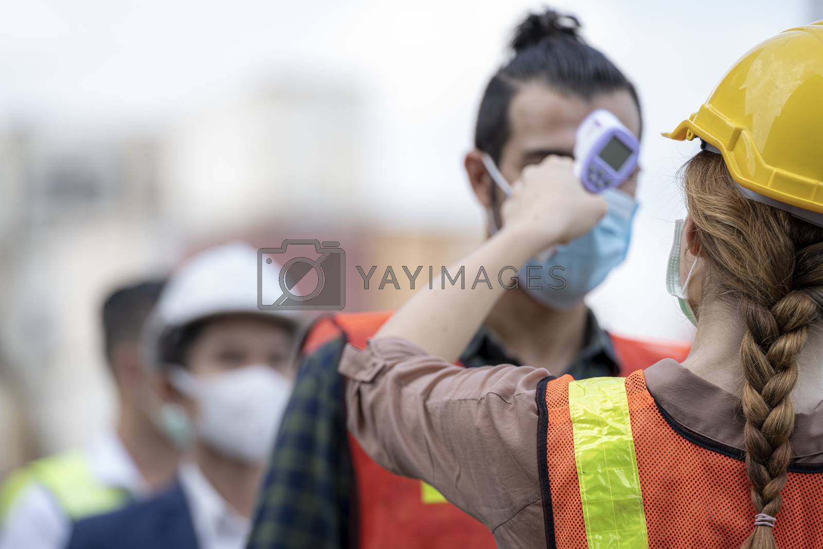 Royalty free image of Factory woman worker in a face medical mask and safety dress use by Ultramansk