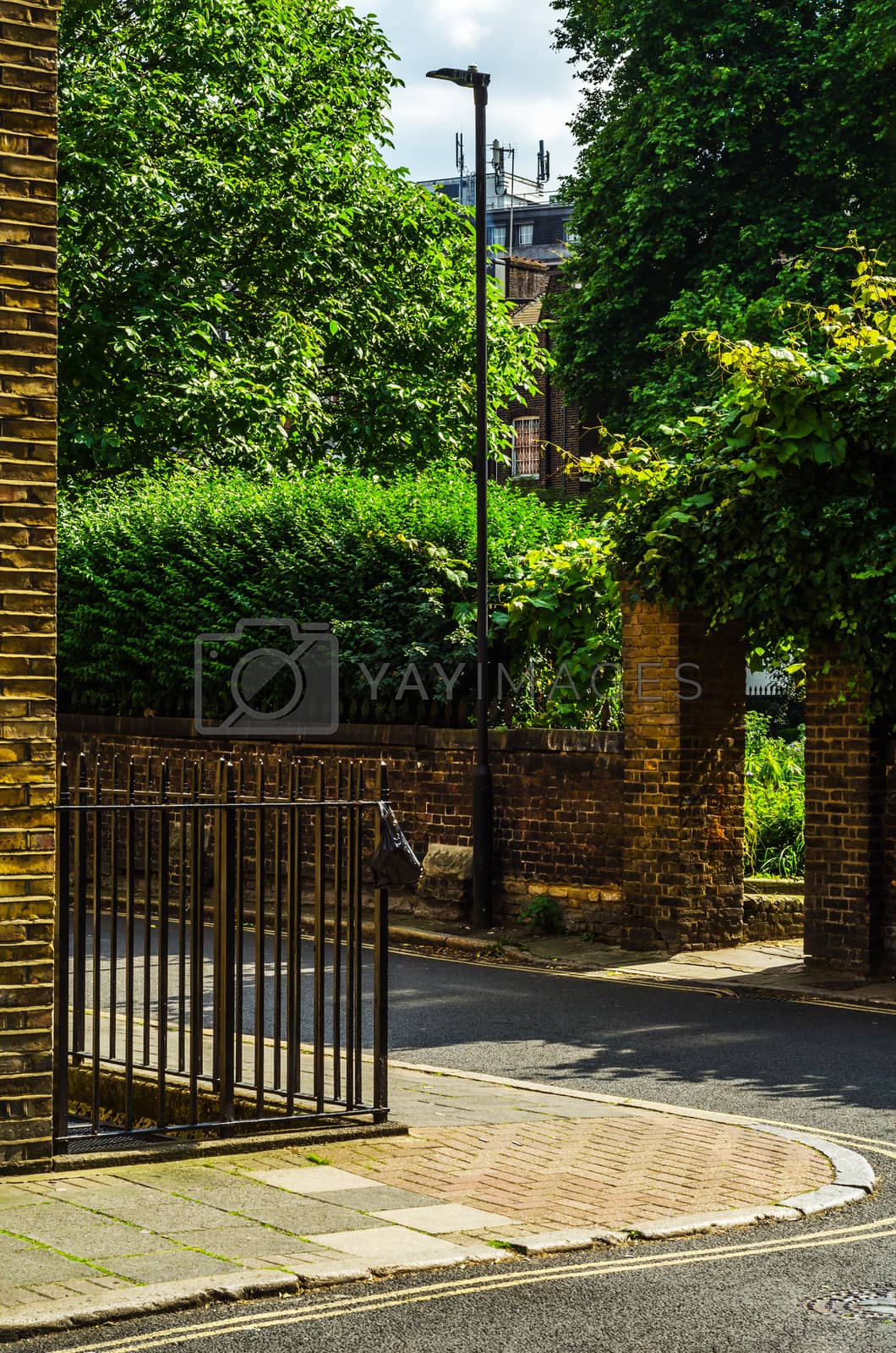 Royalty free image of Typical old English buildings, low brick buildings across a narr by Q77photo
