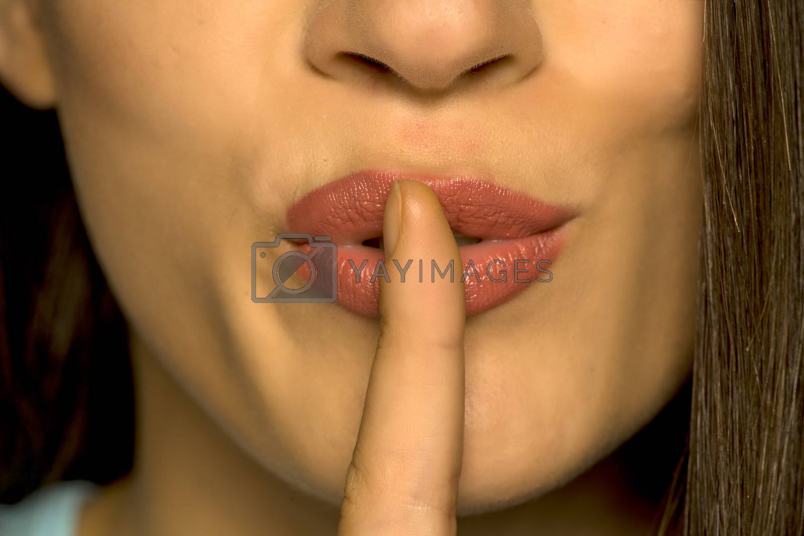Royalty free image of woman with her finger on her lips by Vladimirfloyd