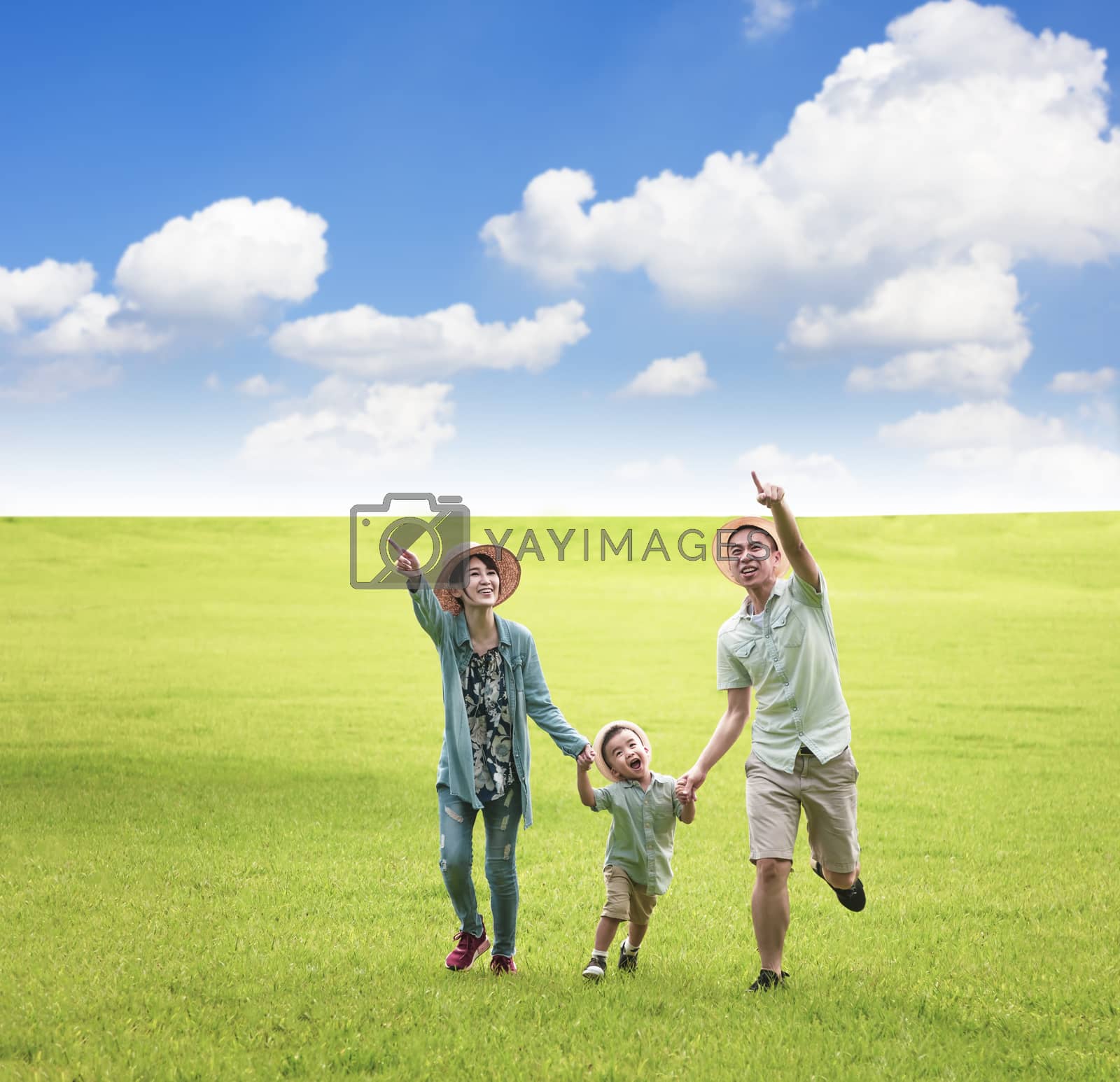 Royalty free image of Happy family  running together on the grass by tomwang