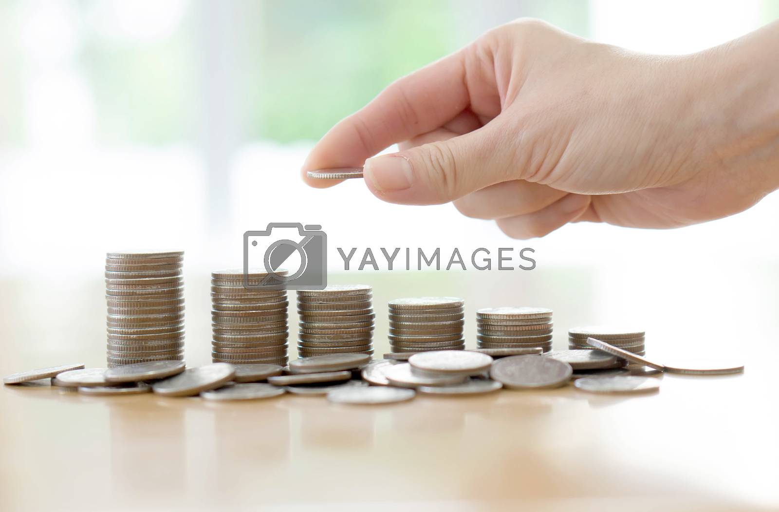 Royalty free image of Hand human hand putting coin to money, business ideas by ekachailo