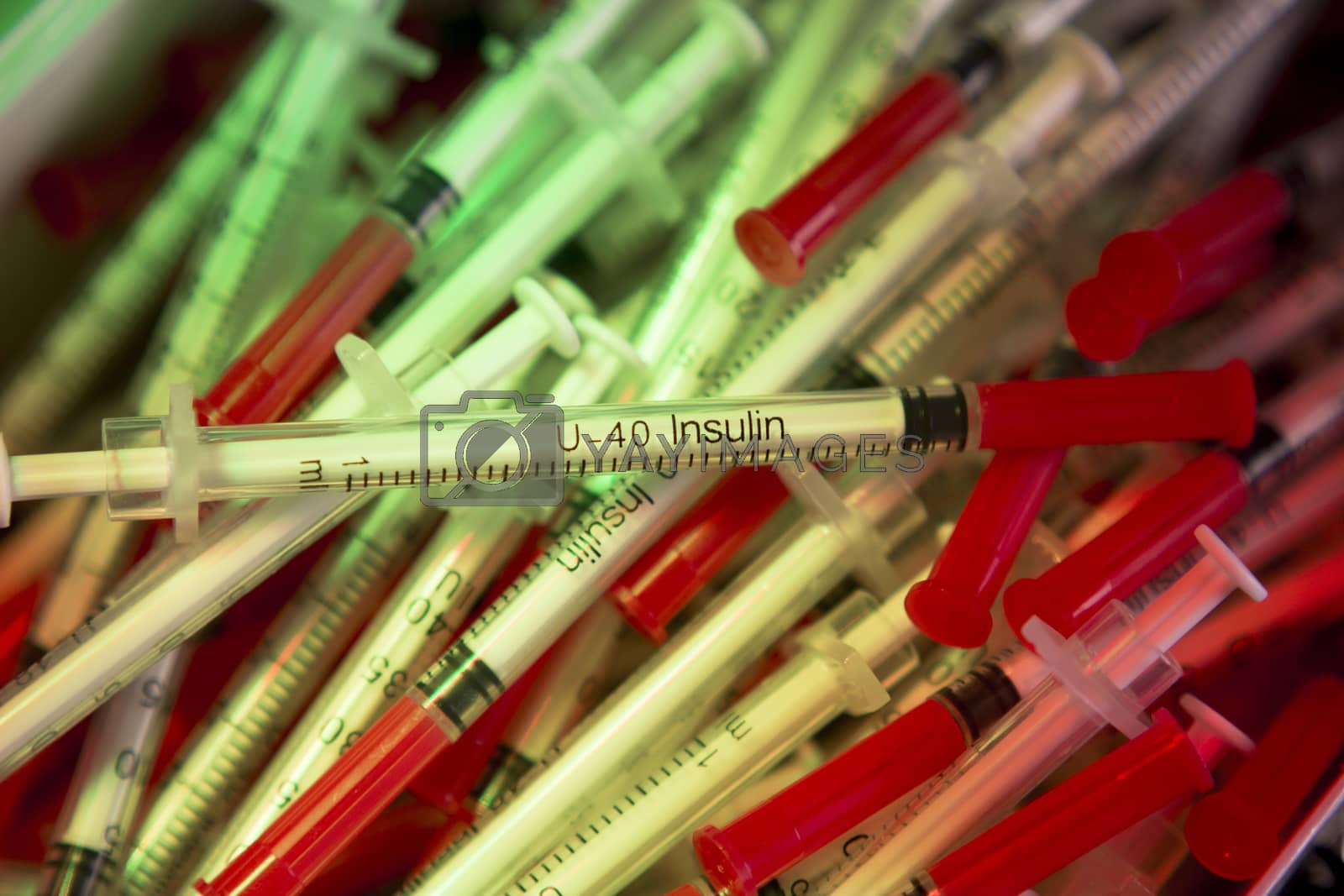 Royalty free image of Syringes on colorful background unfocused by GemaIbarra