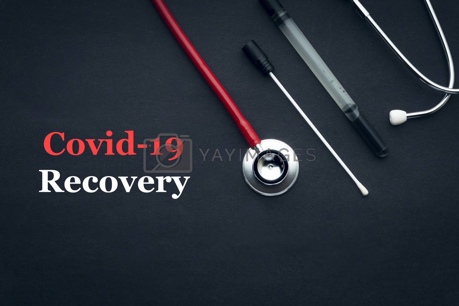 Royalty free image of COVID-19 or CORONAVIRUS RECOVERY text with stethoscope and medical swab black background by silverwings