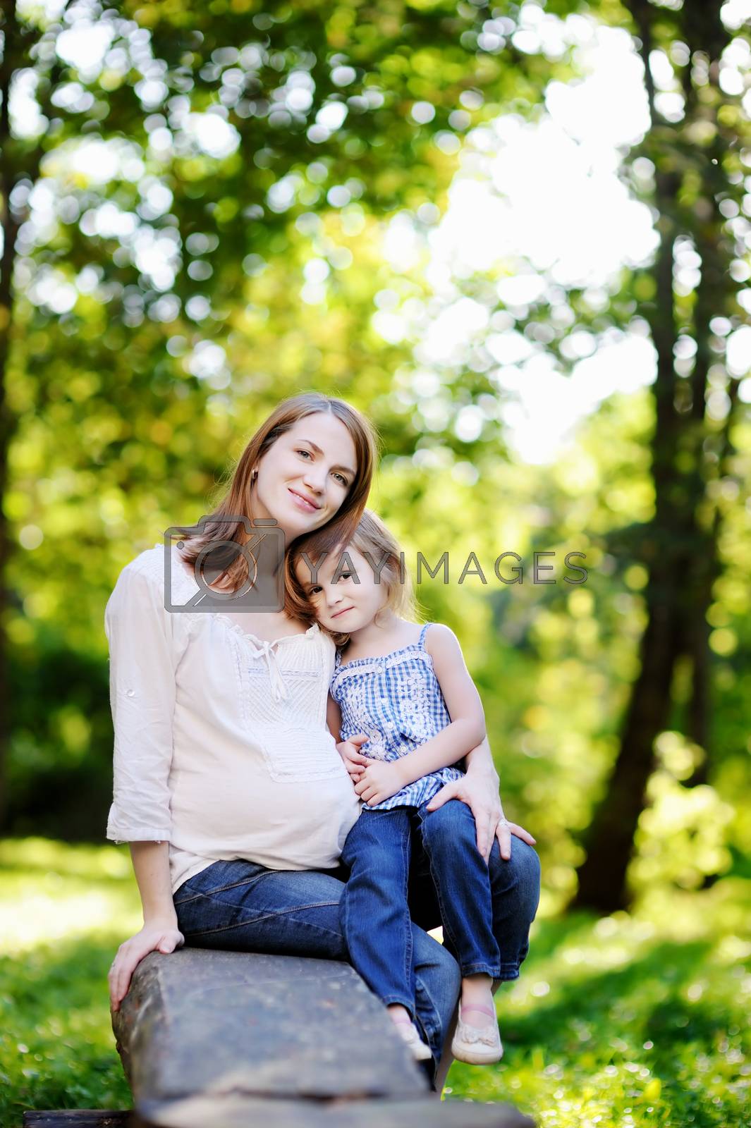 Royalty free image of Pregnant mother with her small daughter by maximkabb