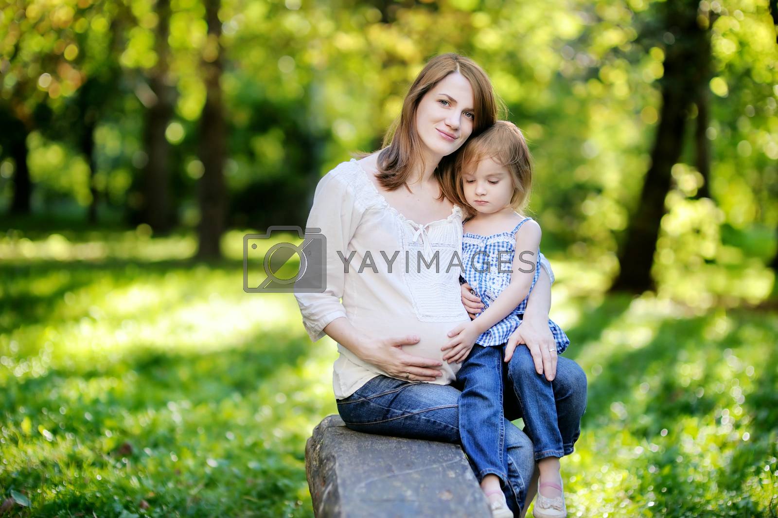 Royalty free image of Pregnant mother with her small daughter by maximkabb