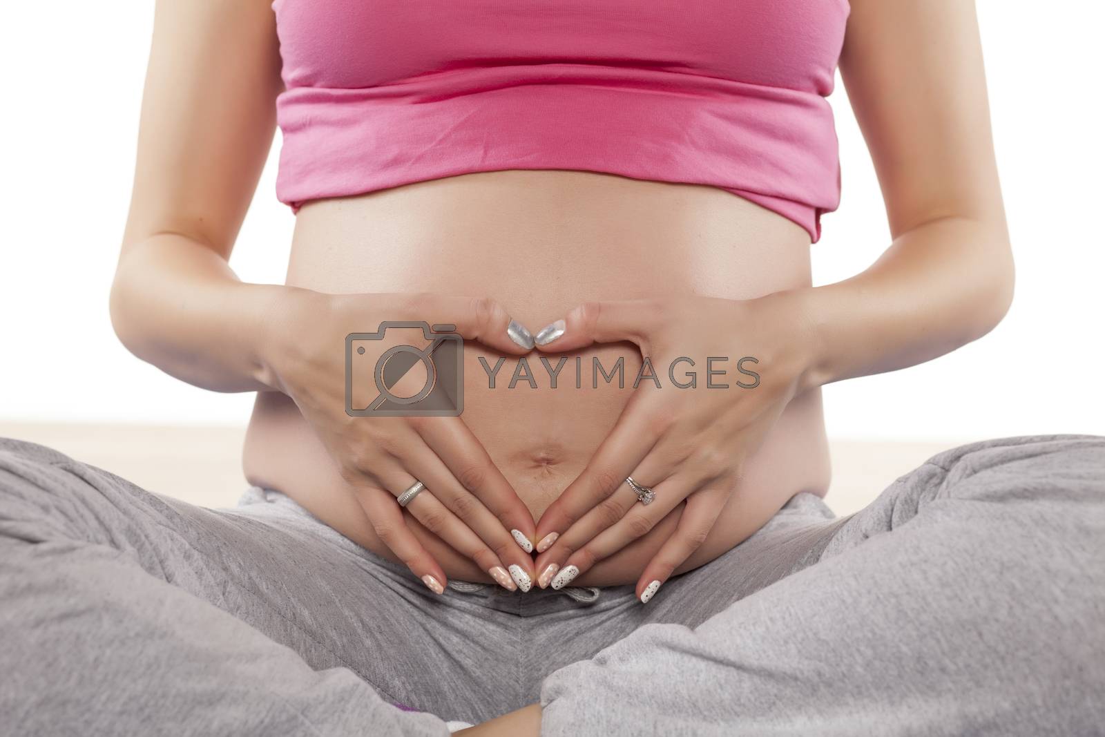 Royalty free image of pregnant woman in sitting position by Vladimirfloyd