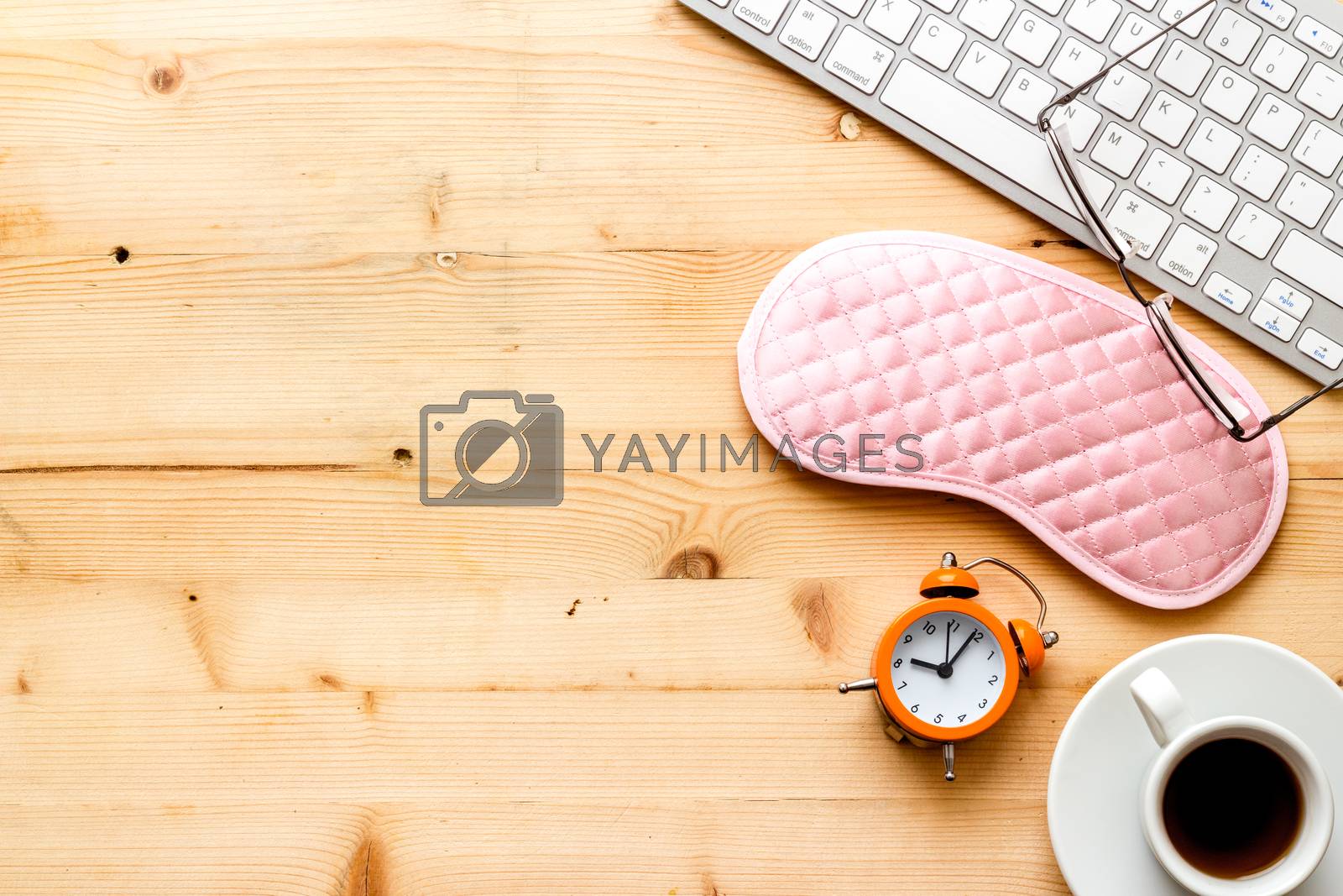 Royalty free image of Sleeping on office desk. Concept with sleep mask and laptop top-down copy space by 9dreamstudio