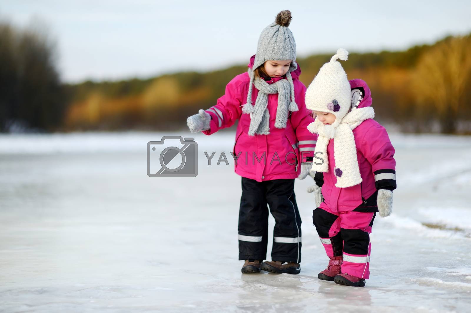Royalty free image of Two little sisters having fun on snowy winter day by maximkabb