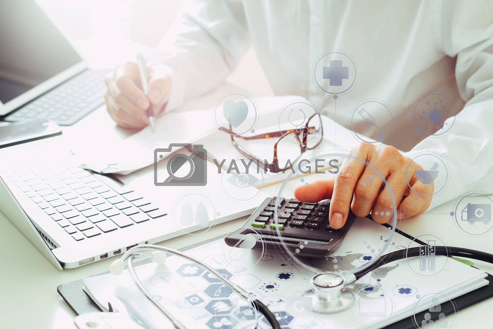 Royalty free image of Healthcare costs and fees concept.Hand of smart doctor used a ca by everythingpossible