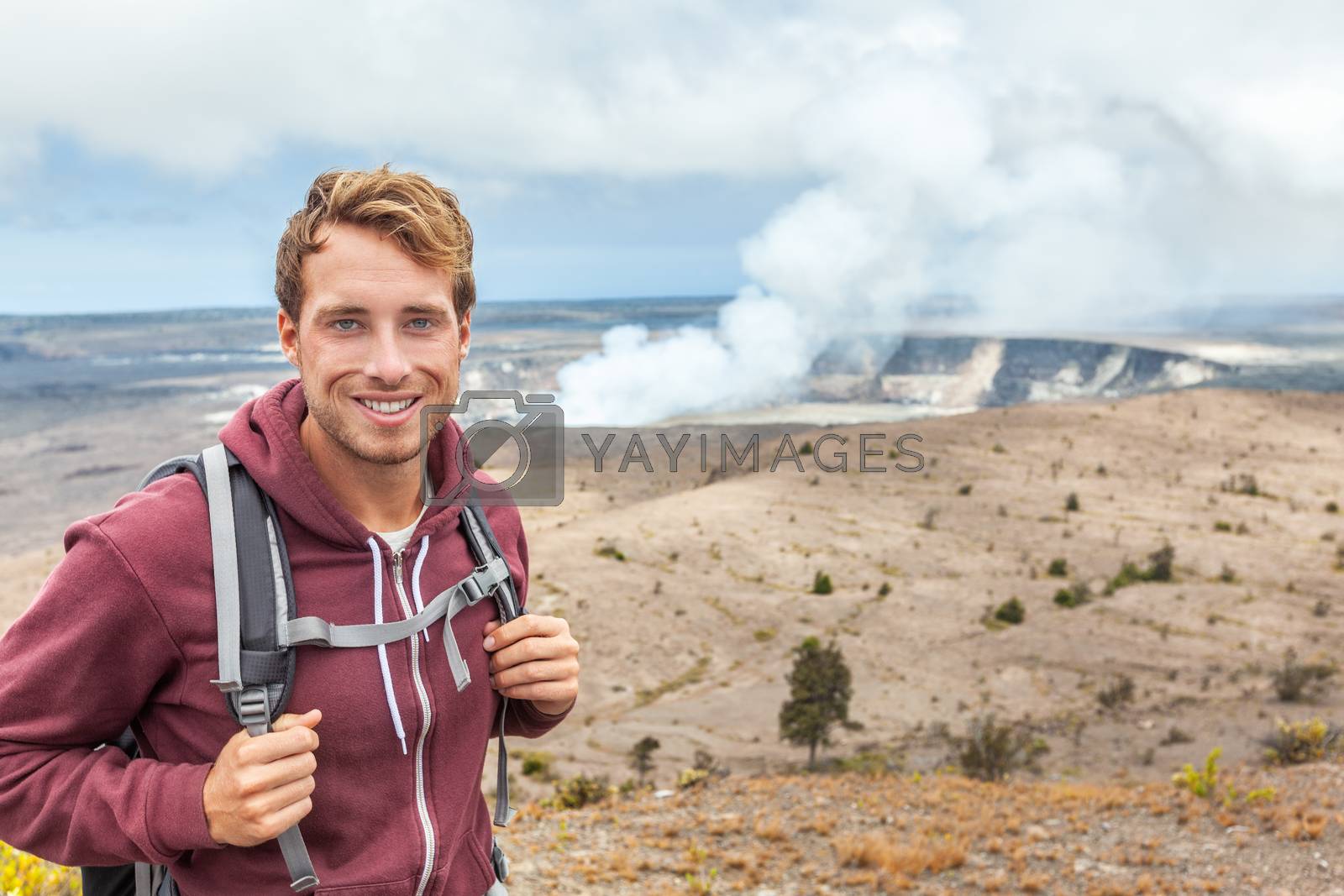 Royalty free image of Hawaii volcano tourist man at Halemaumau crater in Kilauea caldera in Hawaii Volcanoes National Park, big Island with volcanic clouds and ash from eruption. by Maridav