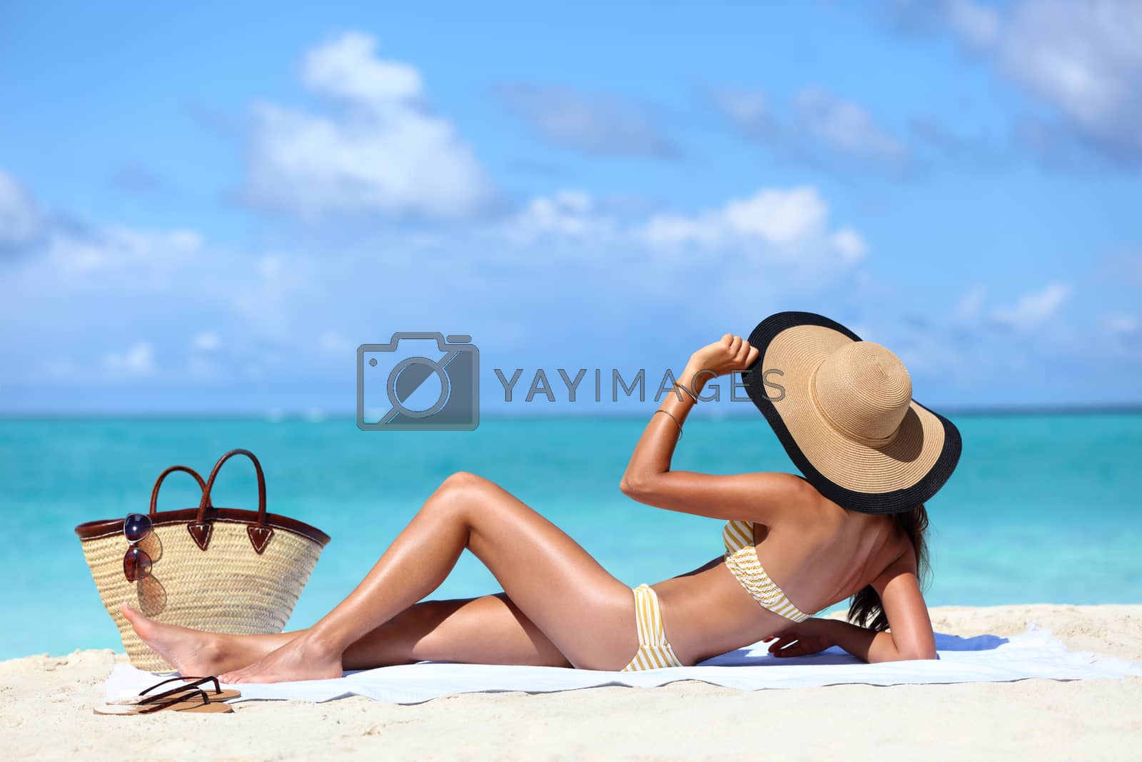 Royalty free image of Sexy hat bikini woman tanning relaxing on beach by Maridav