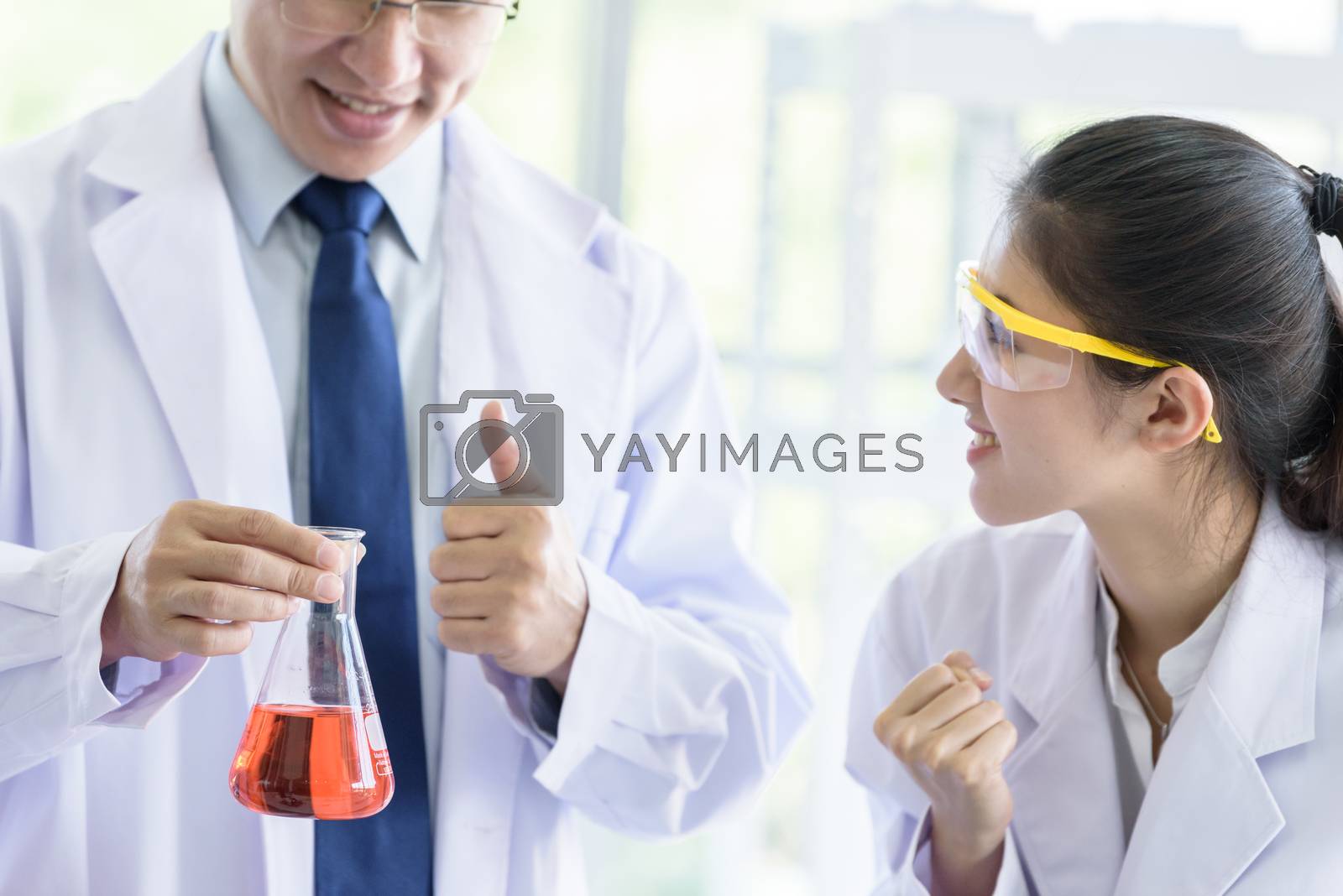 Royalty free image of Asian senior scientist have teaching young student scientist in  by animagesdesign