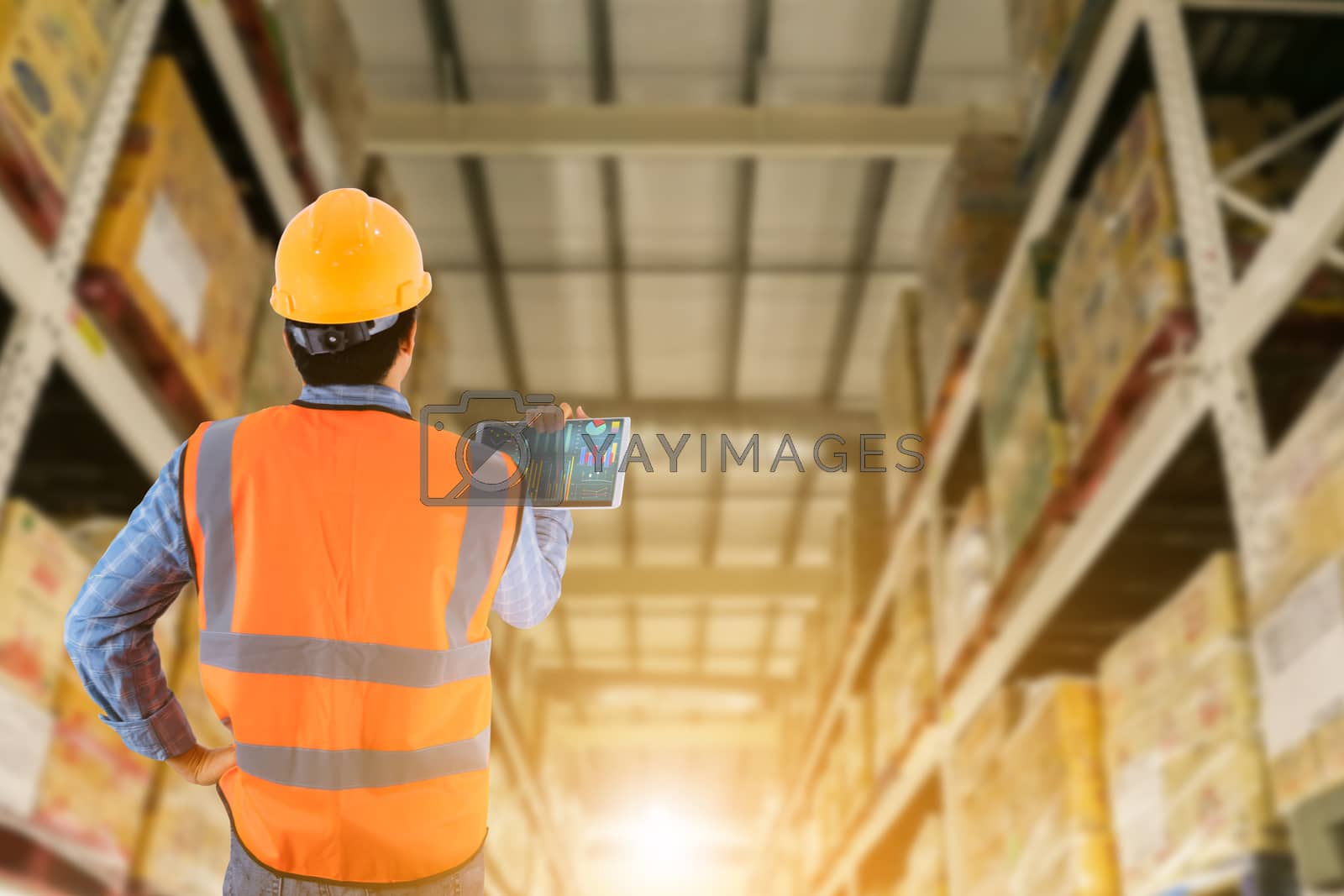Royalty free image of Manager in warehouse business check stock items wholesale indust by sompongtom
