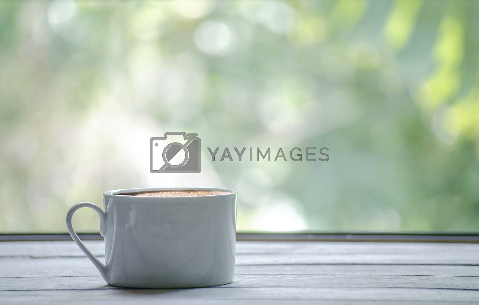 Royalty free image of Coffee cup on table by yodsawai