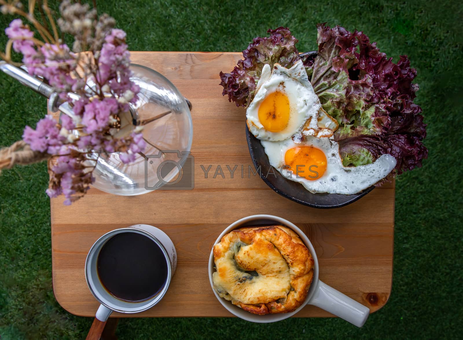 Royalty free image of Breakfast with Spinach brioche, Two fried eggs, Oak Leaf lettuce by tosirikul