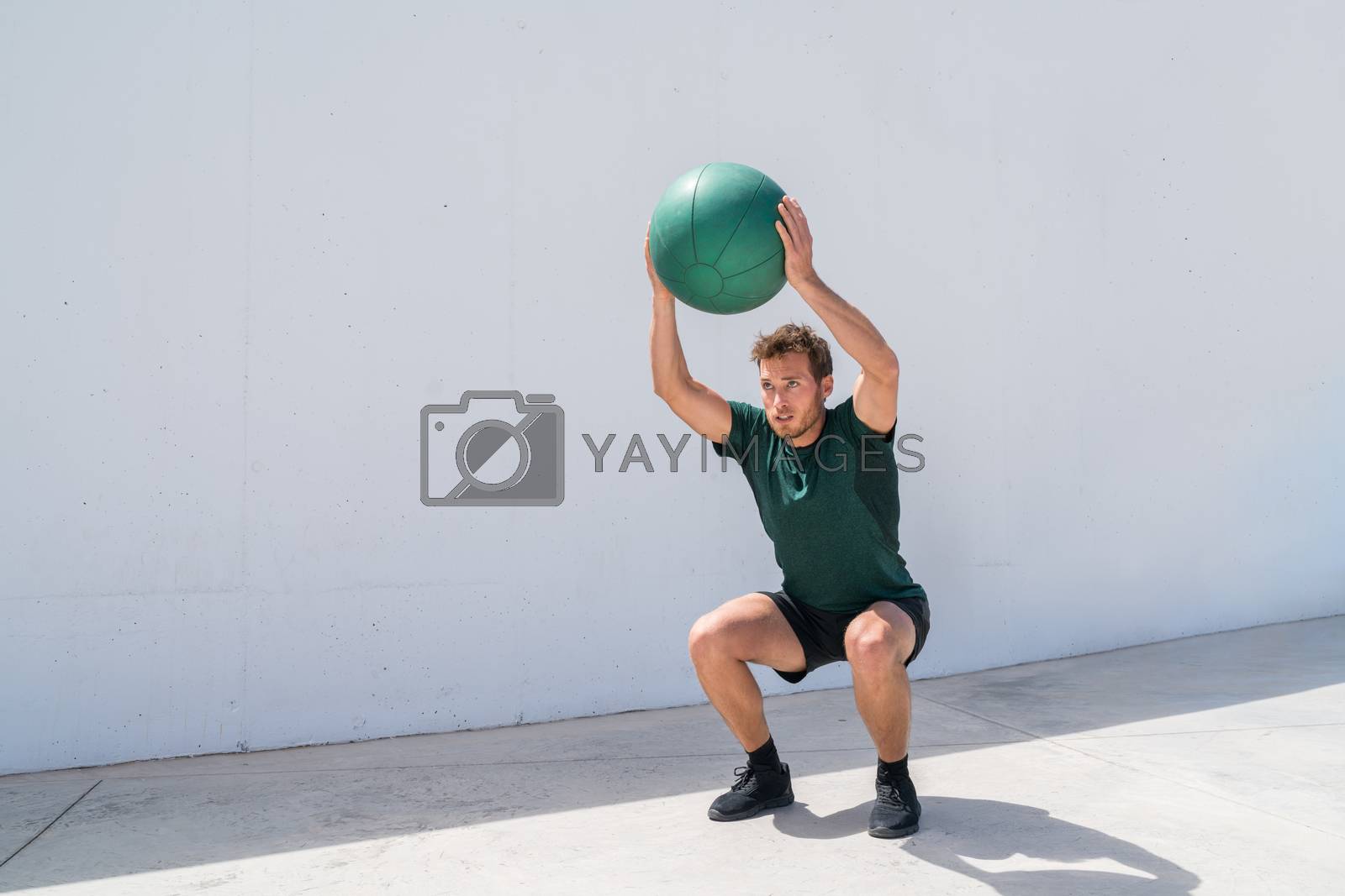 Royalty free image of Weight exercise workout fitness man training squat by Maridav