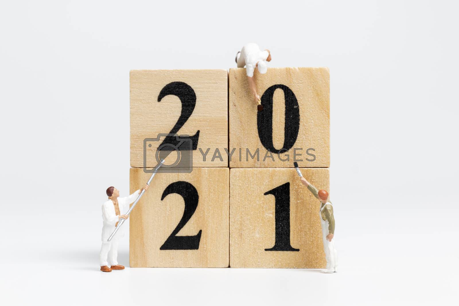 Royalty free image of Miniature worker team painted number 2021 by sirichaiyaymicro