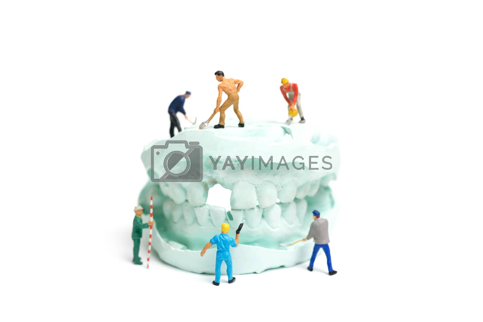 Royalty free image of Miniature Worker team is filing fake teeth by sirichaiyaymicro