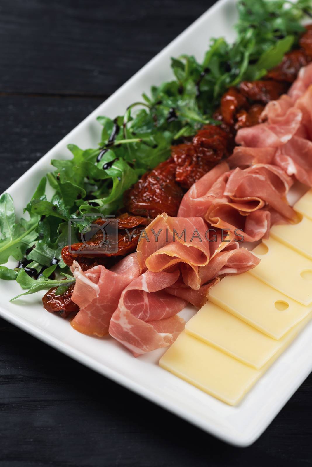 Royalty free image of prosciutto cheese and sun-dried tomatoes by rusak