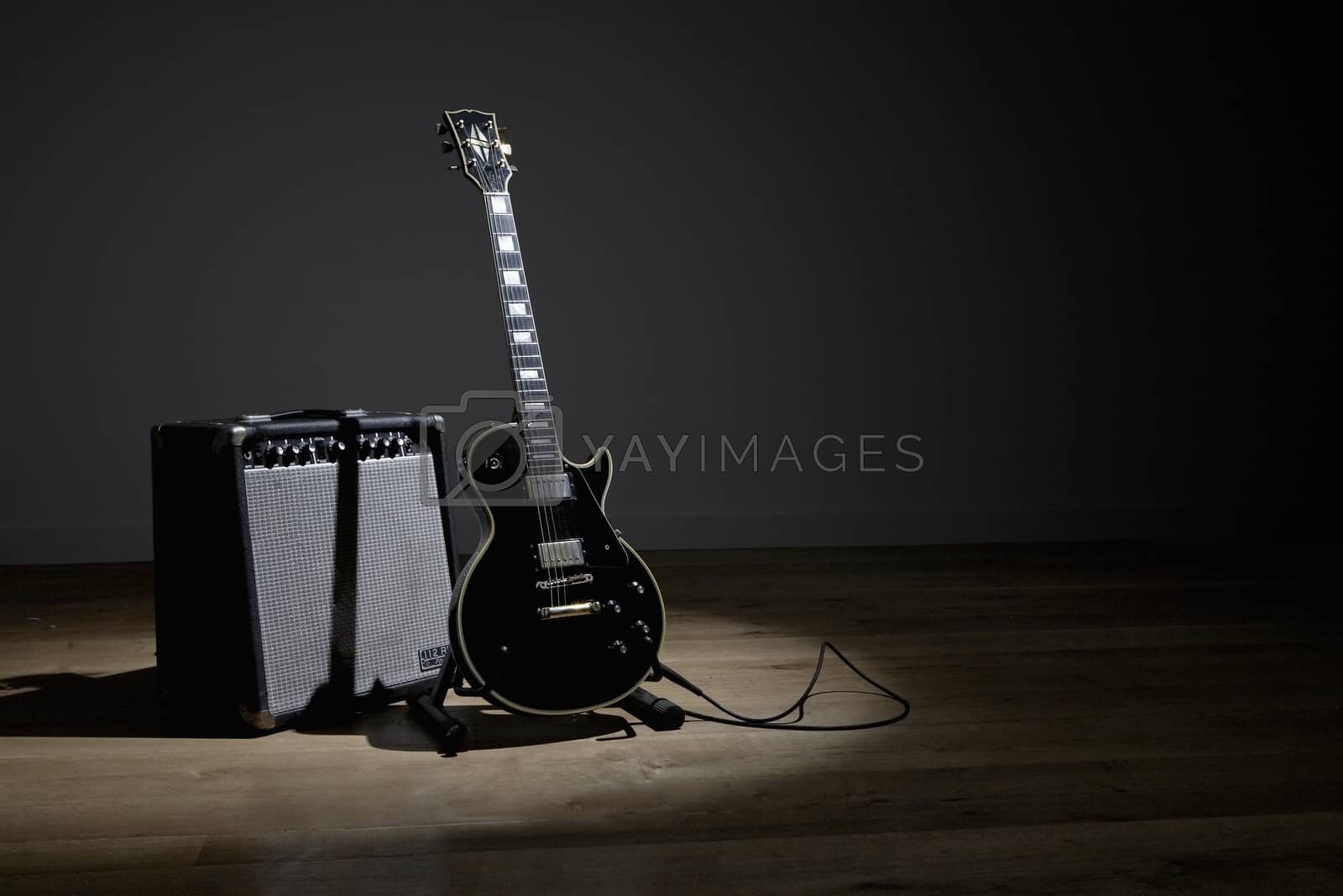 Royalty free image of Electric guitar and amplifier on stage by moodboard