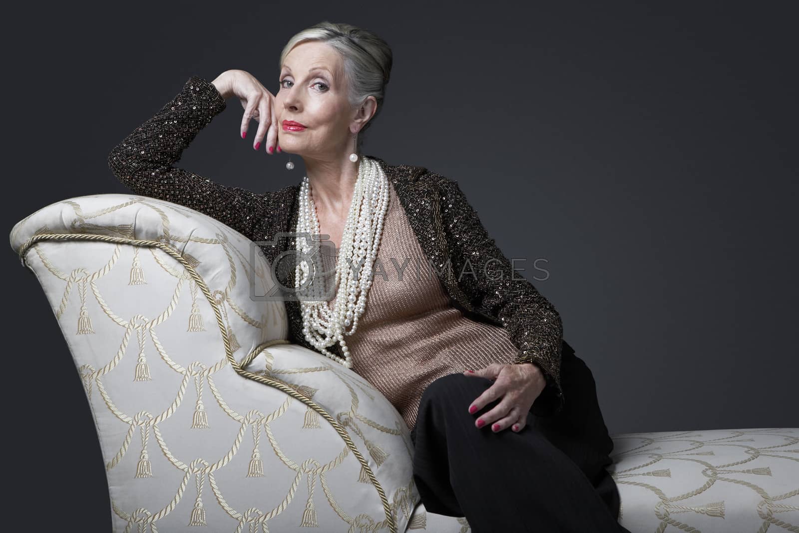 Royalty free image of Wealthy Senior Woman on Chaise Lounge by moodboard
