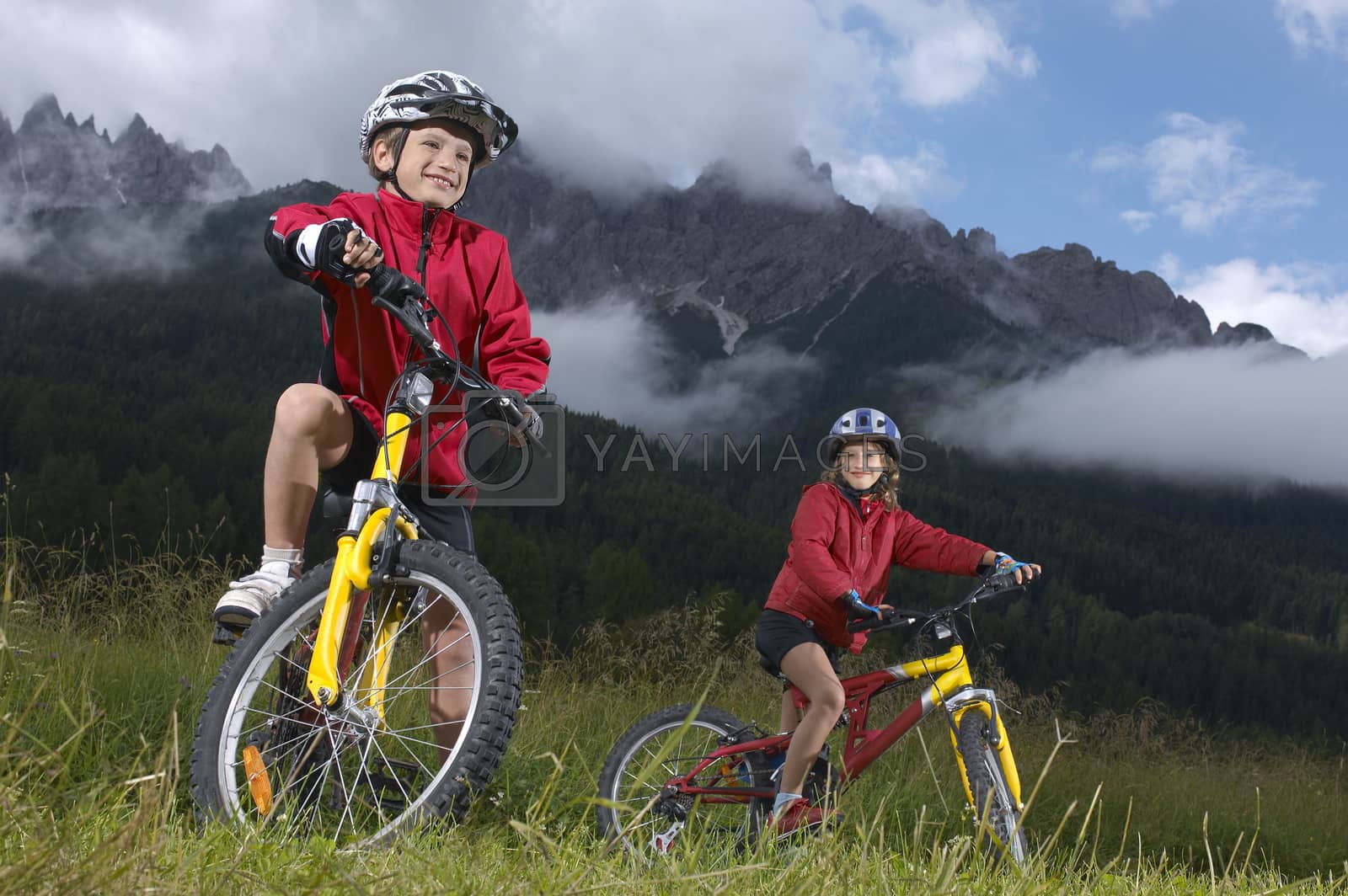 Royalty free image of Brother and sister (7-9) on bikes in countryside by moodboard