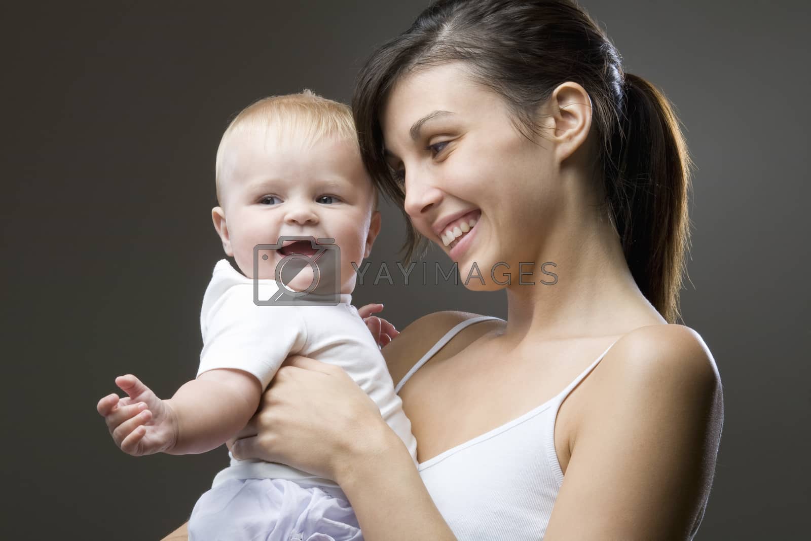 Royalty free image of Mother carrying her baby in studio by moodboard