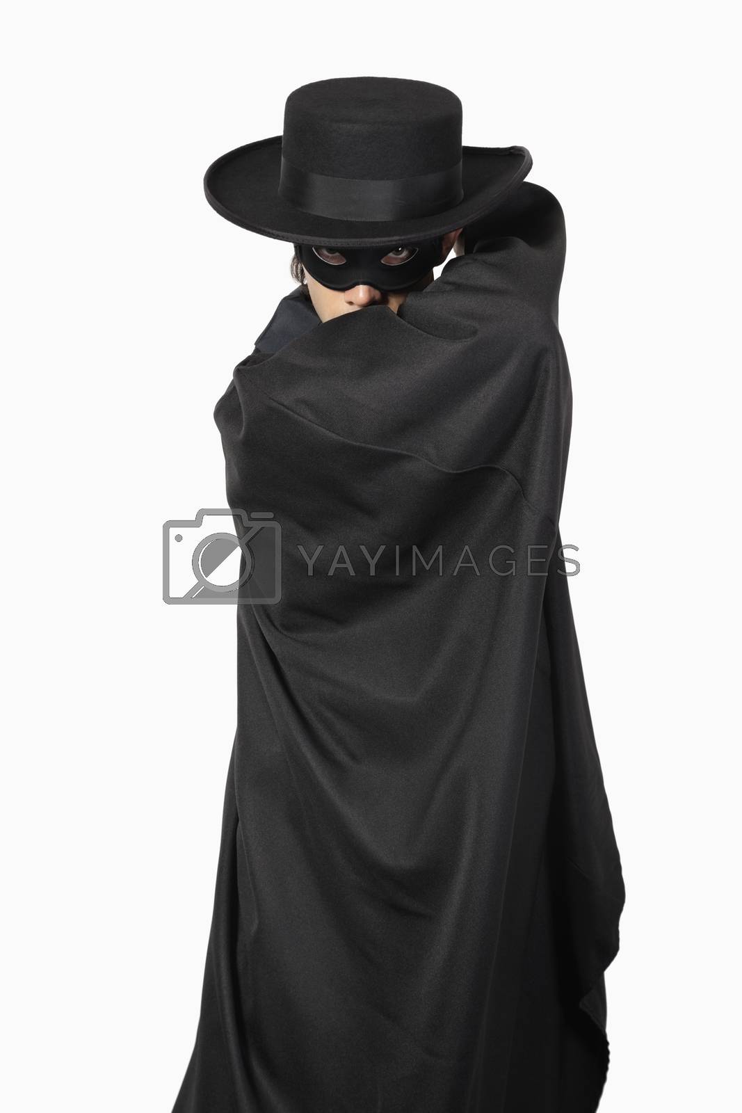 Royalty free image of Portrait of young man dressed as Zorro over gray background by moodboard