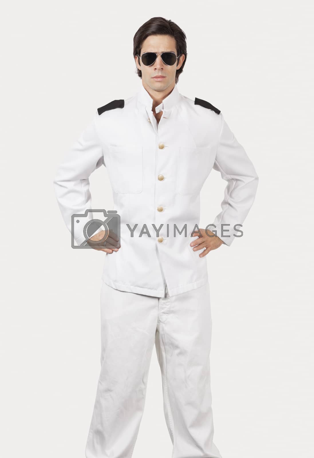 Royalty free image of Portrait of young navy officer standing against gray background by moodboard