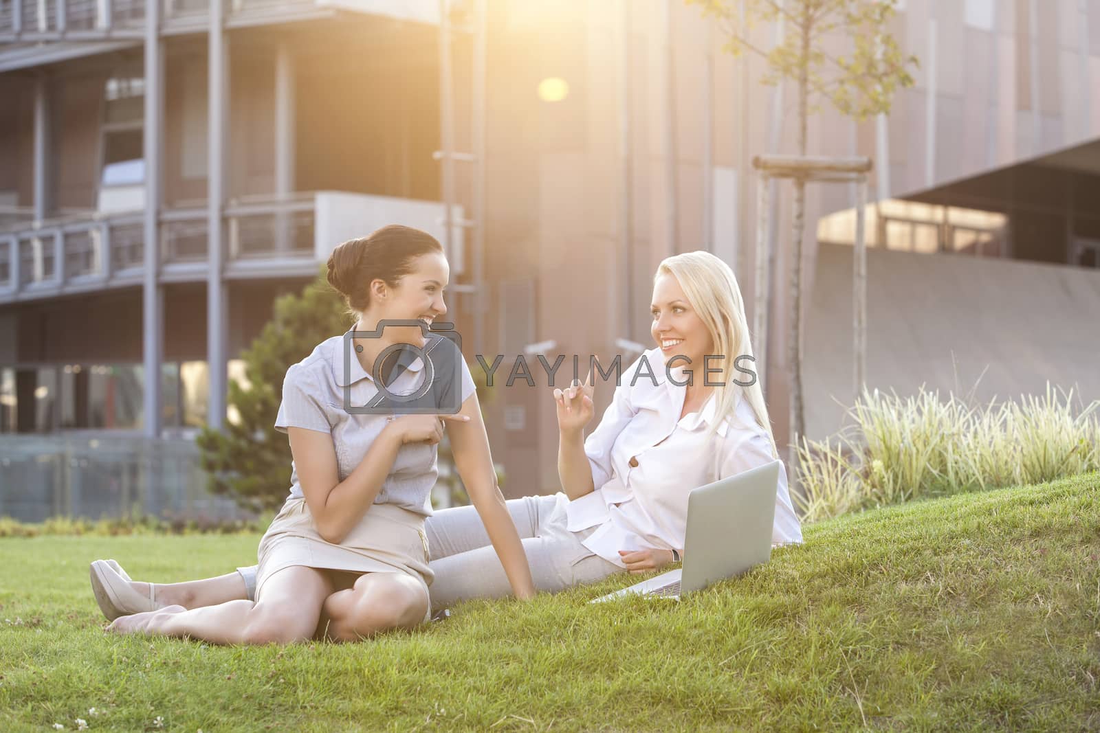 Royalty free image of Young businesswomen spending leisure time on office lawn by moodboard