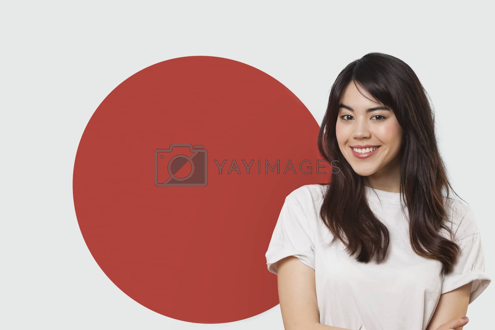 Royalty free image of Portrait of smiling mixed race young woman against Japanese flag by moodboard