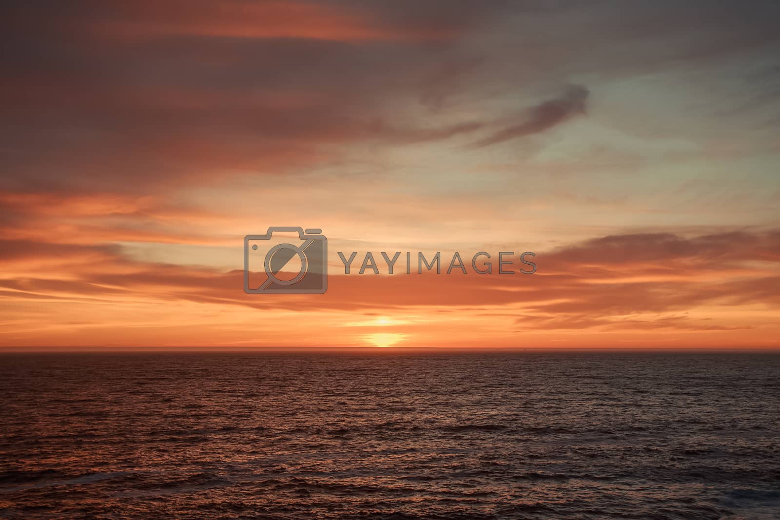 Royalty free image of A massive horizon during a colorful sunset by AveCalvar