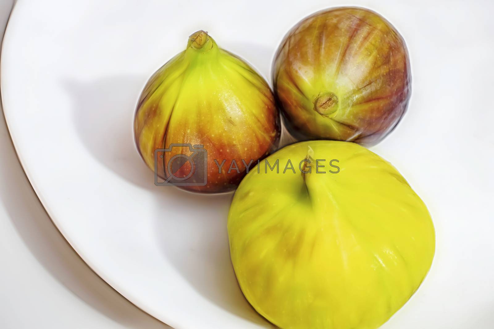 Royalty free image of ready to eat fig fruits on white plate by yilmazsavaskandag