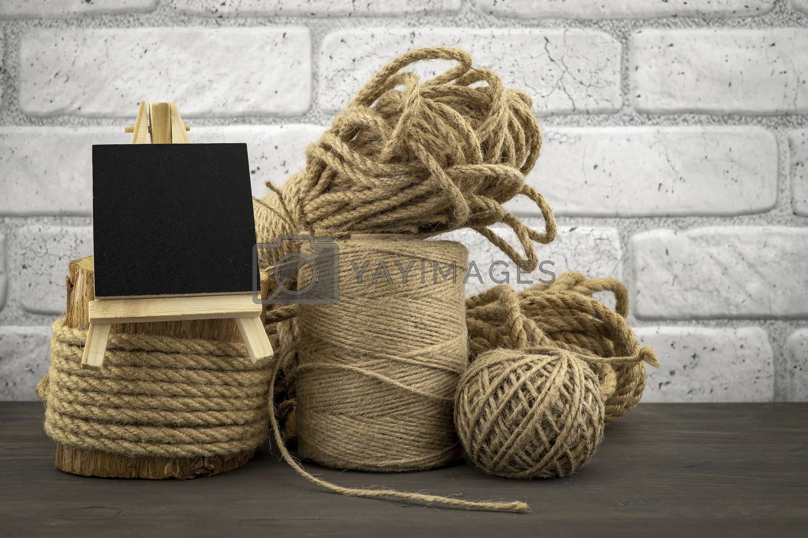 Royalty free image of Assorted balls of hemp twine with rope and slate by NetPix
