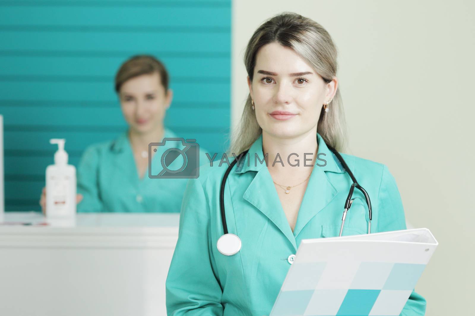 Royalty free image of Two female doctors or nurses looking at the camera. Stethoscope on the neck by selinsmo