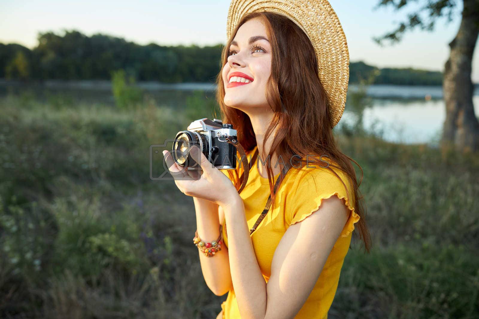 woman photographer with camera looking up hat nature lifestyle. High quality photo