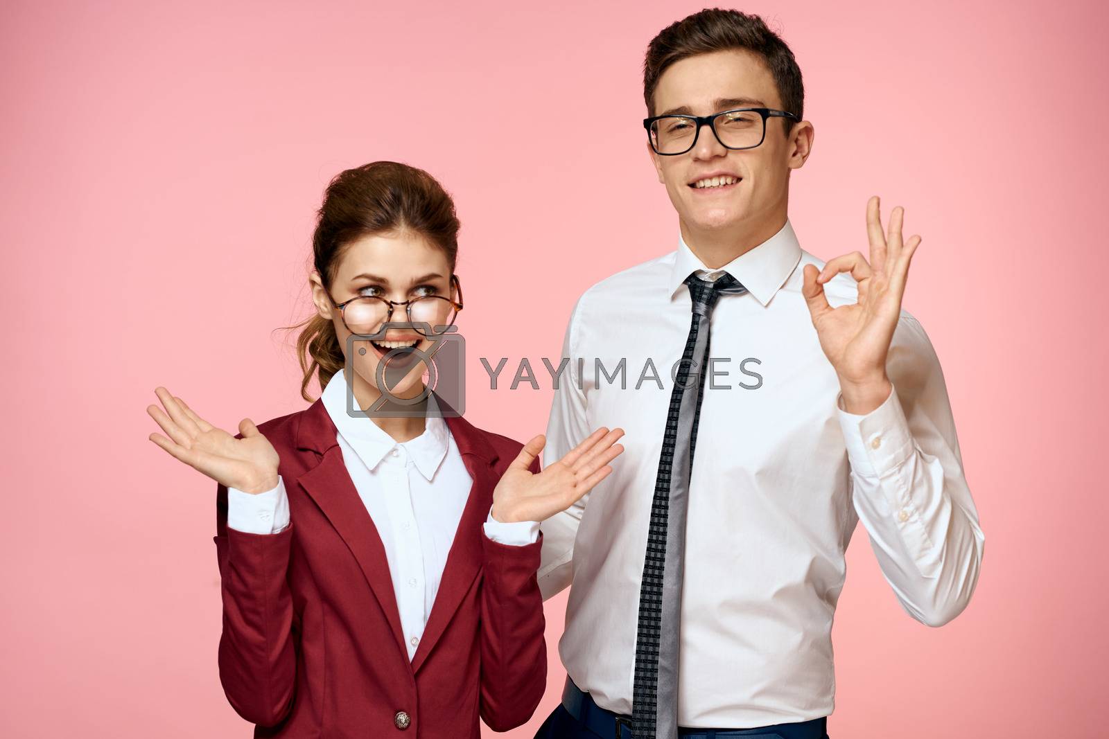 Work colleagues communication emotions officials office pink background. High quality photo