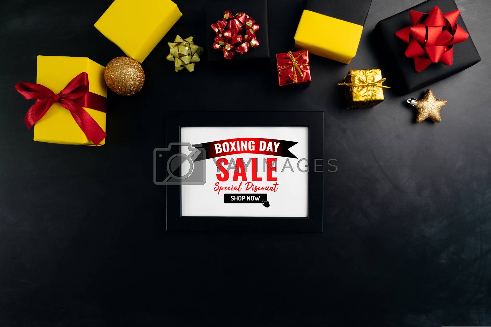 Royalty free image of Boxing day sale with Christmas present and xmas decoration on bl by psodaz