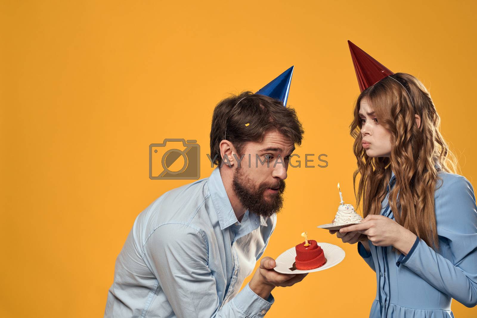 Man and woman fun and celebration Birthday joy vacation yellow background. High quality photo