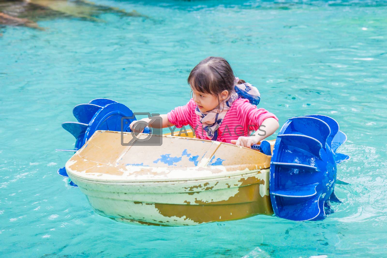 Royalty free image of Young girl in paddle boat by imagesbykenny