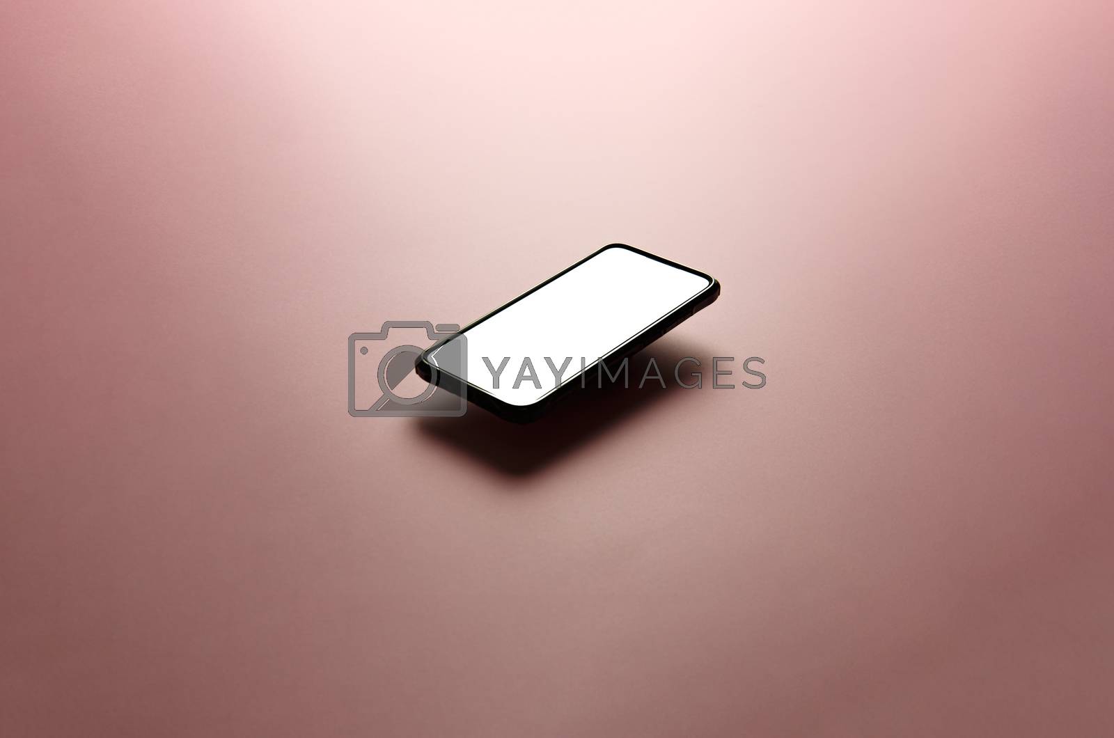 Royalty free image of Minimalistic mock up flat image design with a floating mobile phone with copy space and white scree to write over it over a flat pastel pink background by AveCalvar