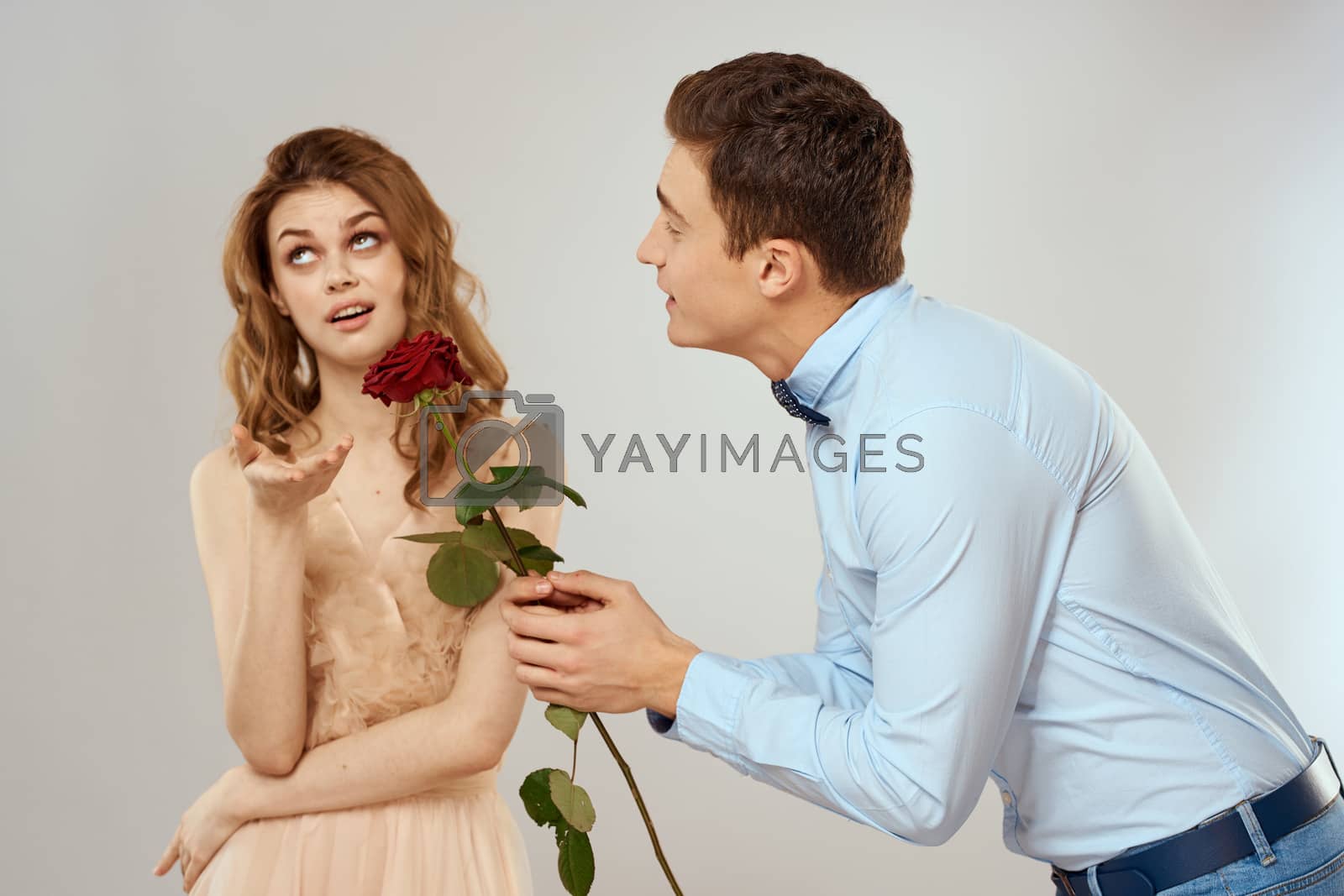 lovers men and woman hugs romance love red rose light background. High quality photo