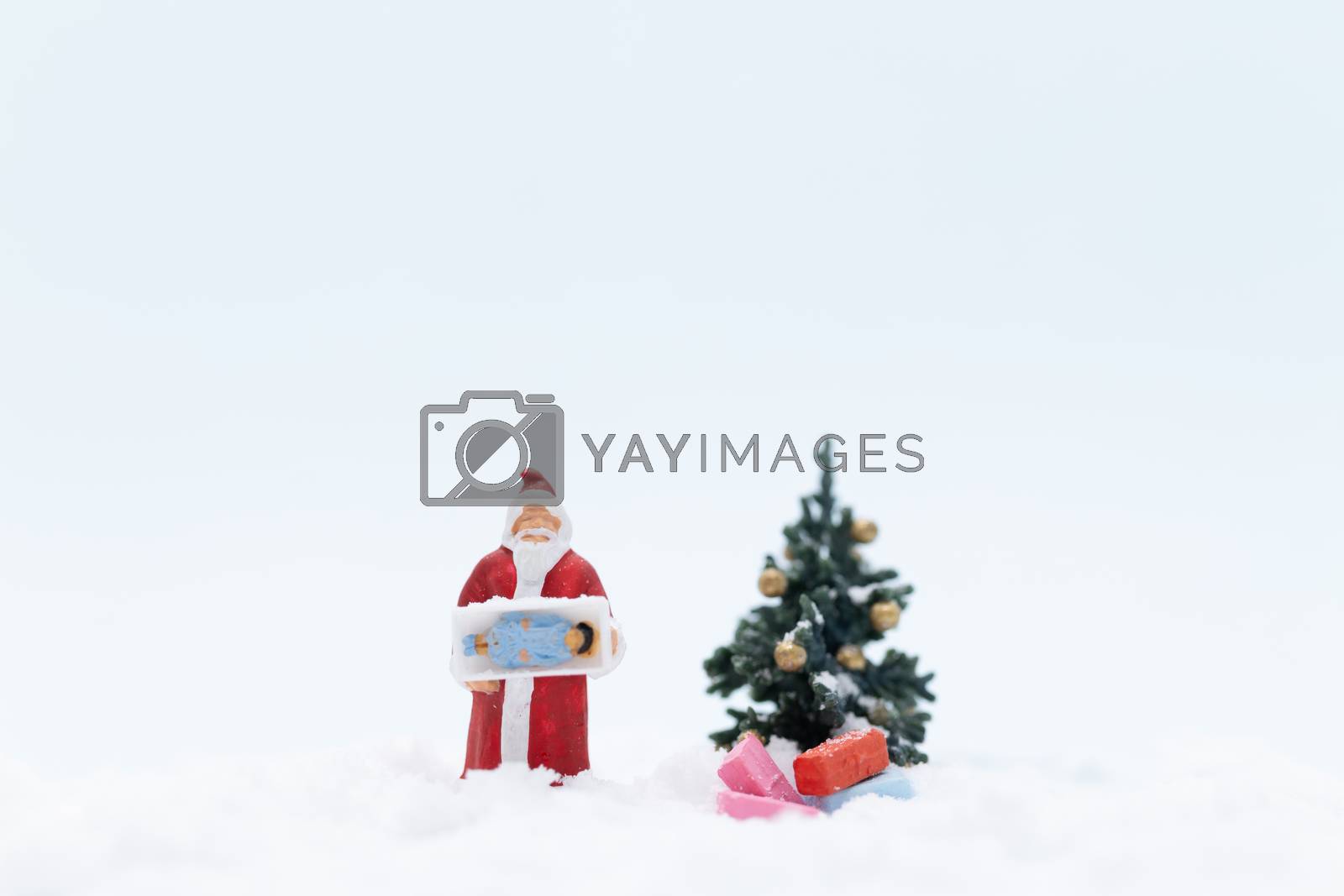 Royalty free image of Miniature people, Santa claus and gifts for kid by sirichaiyaymicro