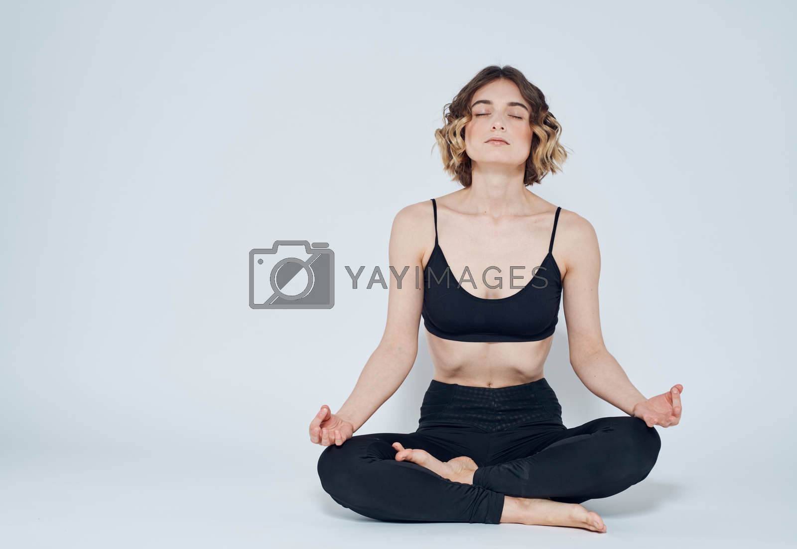 Woman with crossed legs meditate while sitting on the floor of yoga asana. High quality photo