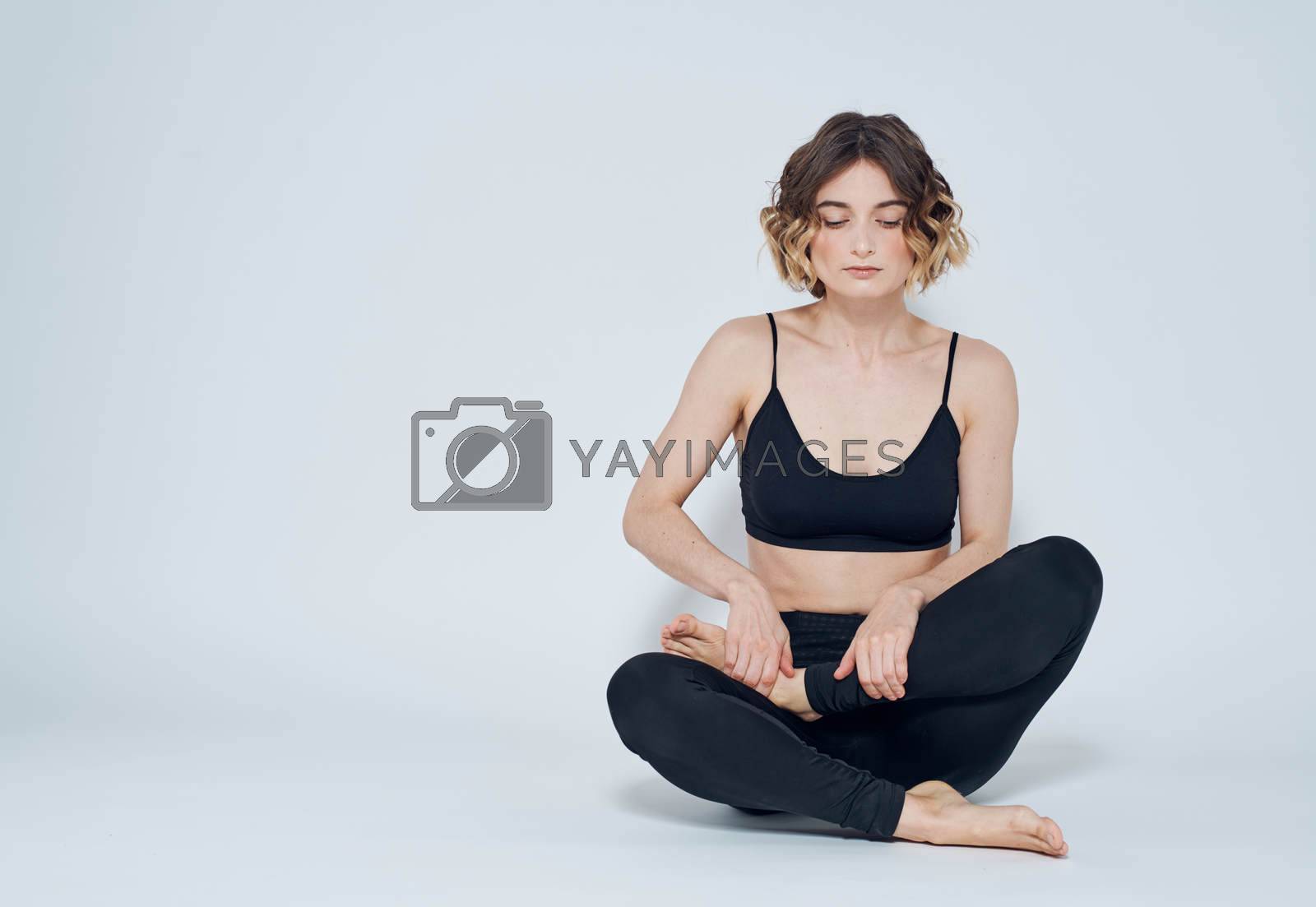 Woman meet legs sitting on the floor meditation yoga asana. High quality photo
