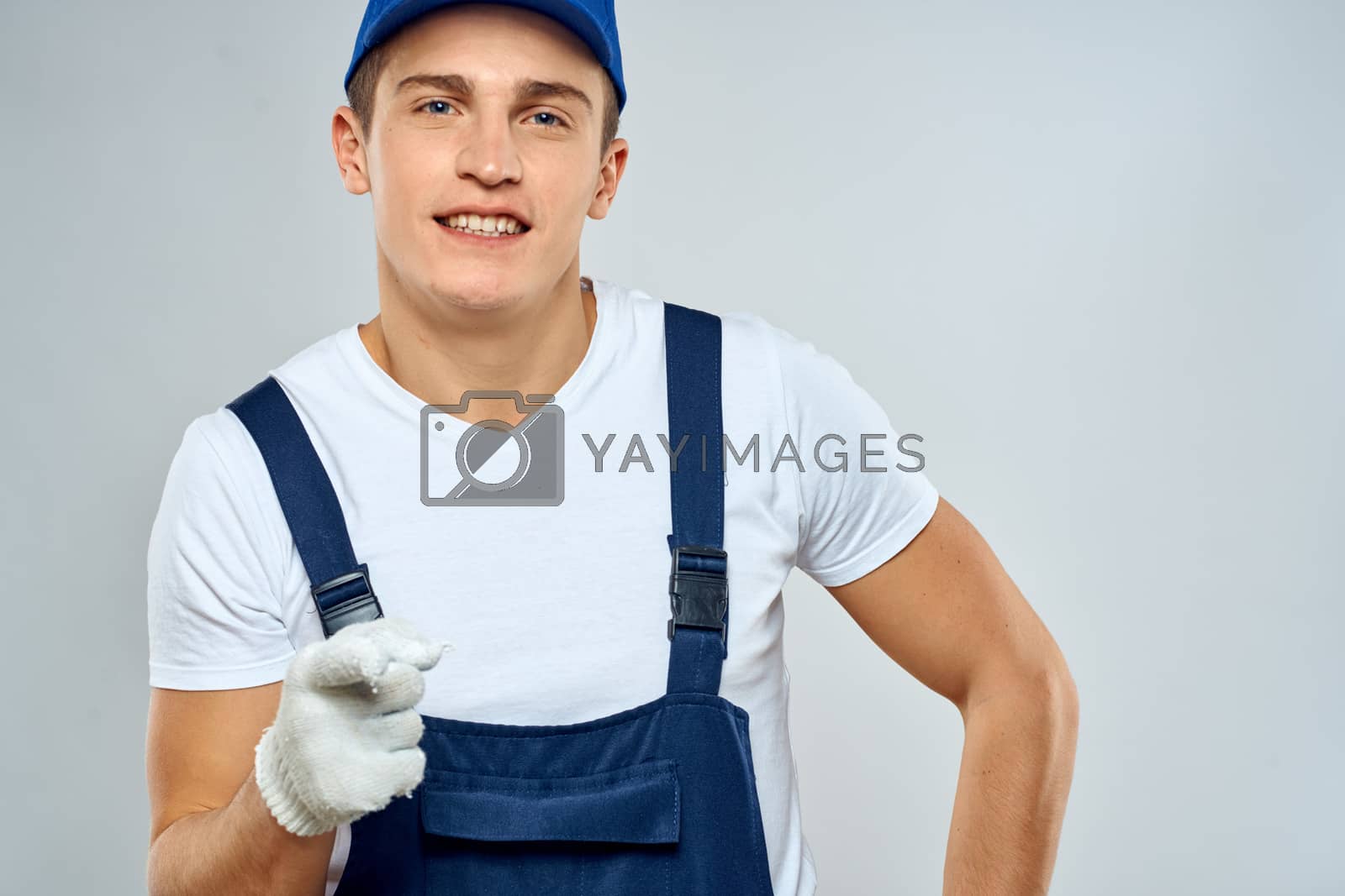 Royalty free image of Man worker in forklift uniform delivery service light background by SHOTPRIME