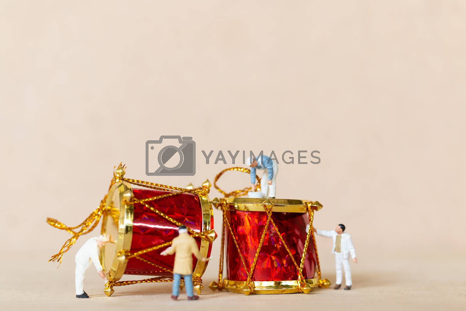 Royalty free image of Miniature people,  Worker team painting a Christmas decoration by sirichaiyaymicro