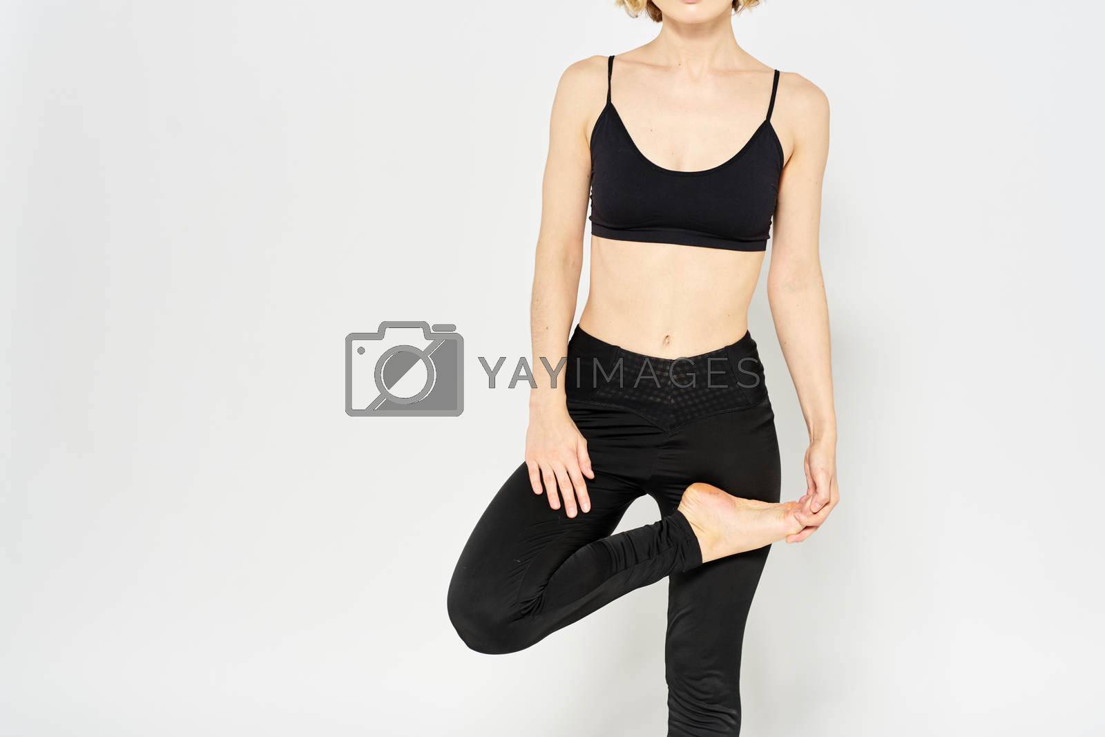 Woman in sportswear on a light background exercise fitness sport balance model. High quality photo