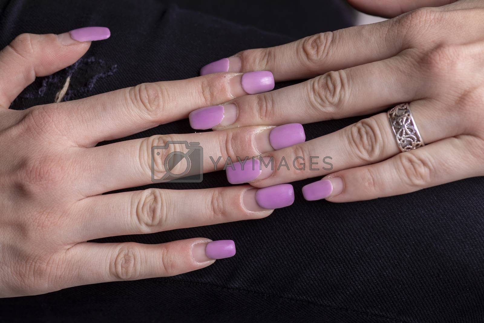 Royalty free image of Overgrown gel polish nails manicure. Female hands with overgrown by adamr